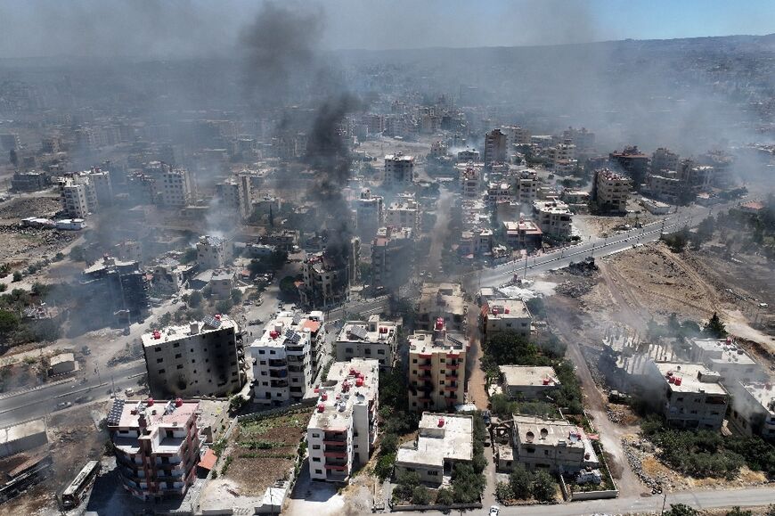 Smoke rises over the Syrian city of Sweida as AFP correspondents report gunfire and explosions in several neighbourhoods despite a ceasefire ordered by the Islamist-led government.