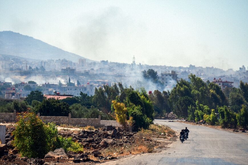 Smoke billows amid ongoing clashes in Syria's southern city of Sweida on July 16, 2025