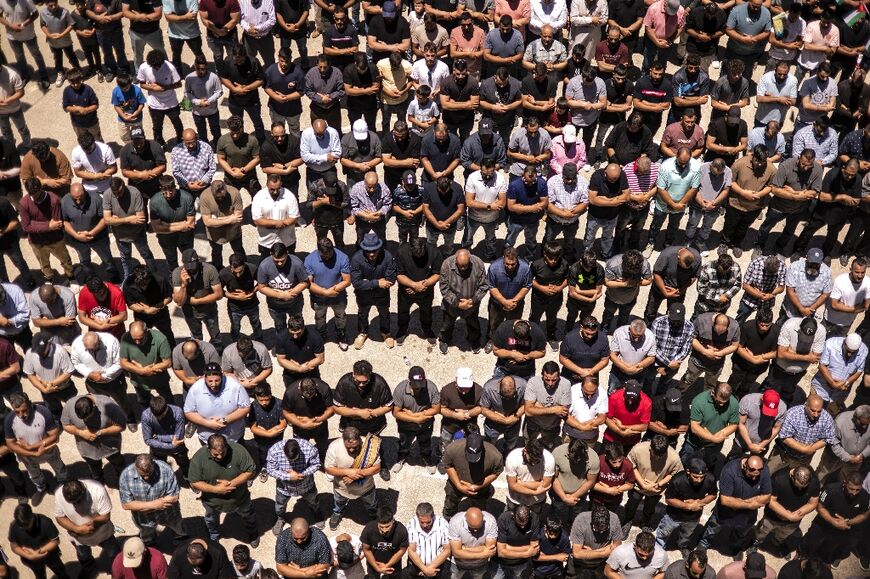 Hundreds of people turned out in the village of Al-Mazra'ah ash Sharqïyah in the occupied West Bank as they were buried on Sunday.