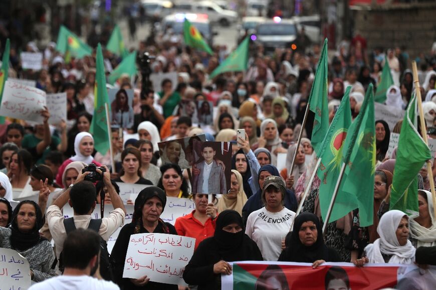 Syrian Kurdish women demonstrate in the northeastern city of Qamishli in support of the Druze in Sweida.