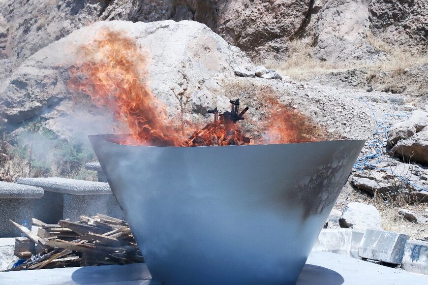 A first group of PKK militants burnt their weapons at a symbolic ceremony in northern Iraq 