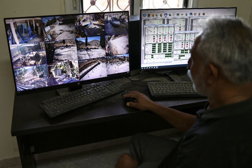 Subhil Olayan monitors screens at the pumping station near the Ein Samiyah spring in the Israeli-occupied West Bank
