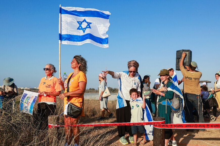 Israeli right-wing protesters gather on a hill overlooking Gaza to call for the re-occupation of the territory