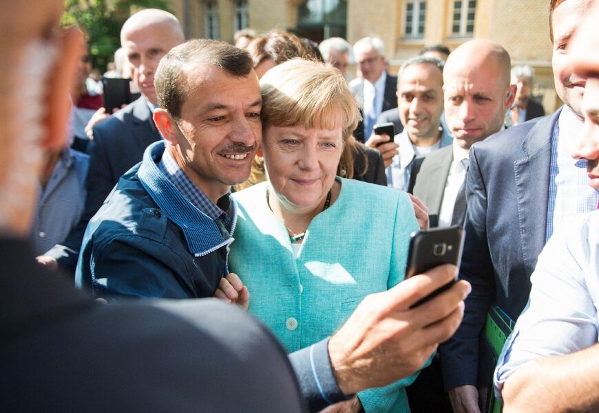 Mutti's big gamble: an asylum seeker takes a selfie with former German leader Angela Merkel in 2015