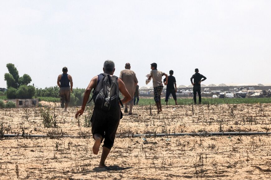 Palestinians rush towards the aid drops