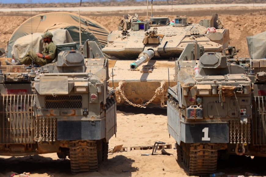 Israeli military vehicles are positioned along the border with the Gaza Strip