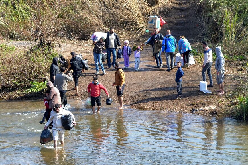 People fleeing the sectarian violence in Syria's predominantly Alawite coastal region cross into Lebanon in March