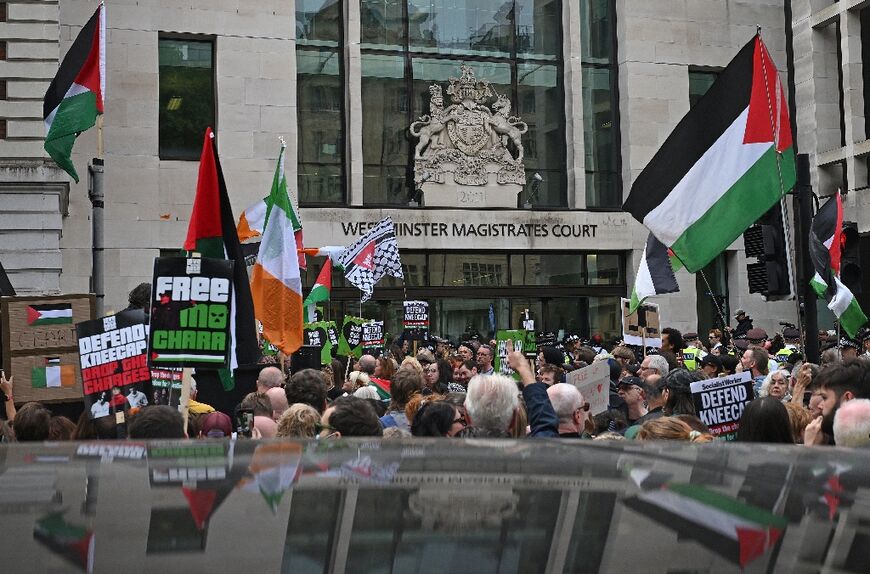 Supporters of the Irish rap band Kneecap fly Palestinian flags outside Westminster Magistrates' Courts in London 