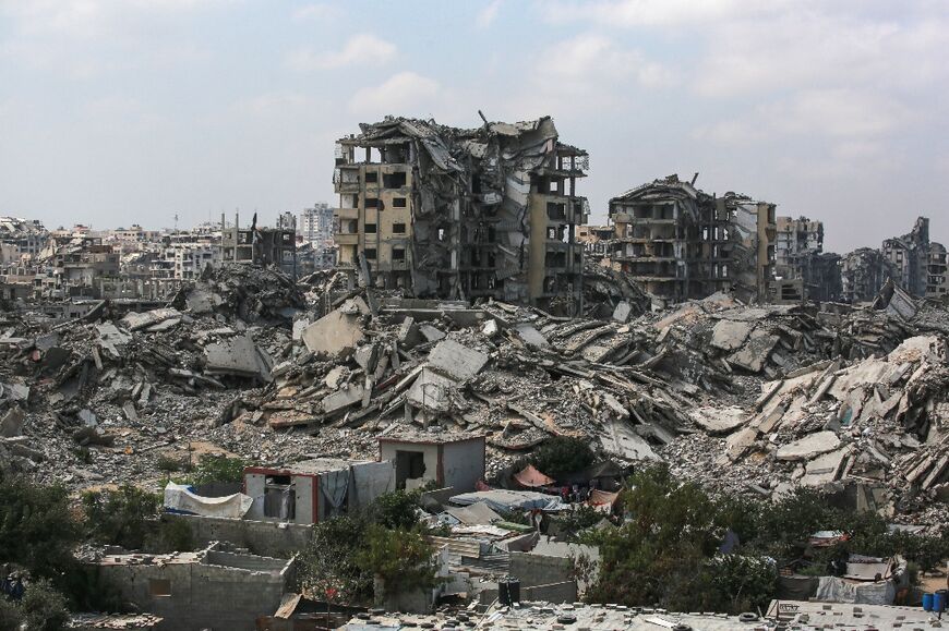 Buildings destroyed in Israeli strikes surround makeshift shelters for displaced Palestinians in Gaza City on August 8, 2025