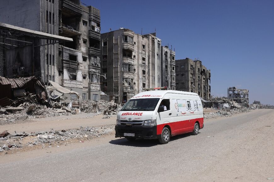 An ambulance drives past bombed out buildings in Jabalia in the northern Gaza Strip.