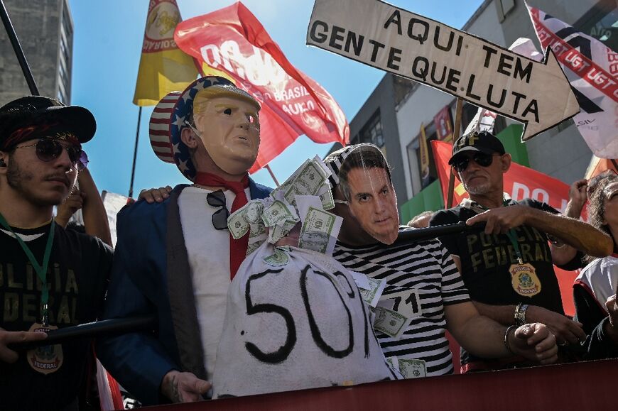 Protesters in Sao Paolo wear masks depicting US President Donald Trump and former Brazilian President Jair Bolsonaro to decry Washington's trade war with Latin America's largest economy
