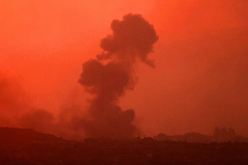 This picture taken from a position on Israel's border with the Gaza Strip, shows smoke billowing during an Israeli strike on the besieged Palestinian territory, at sunset on August 21, 2025