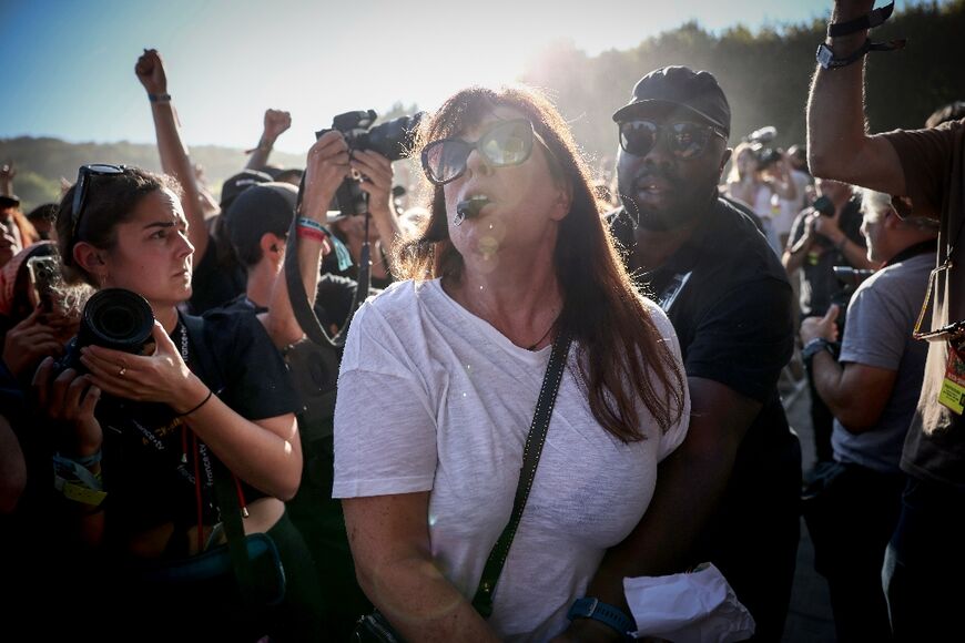 A demonstrator is removed by security after trying to interupt the concert with a whistle while the band performs on stage 