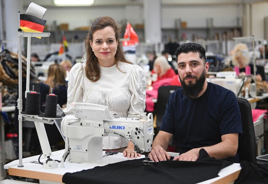 Bonita Grupp, CEO of textile group Trigema, with her Syrian worker Habash Mustafa, who has just got his German nationality