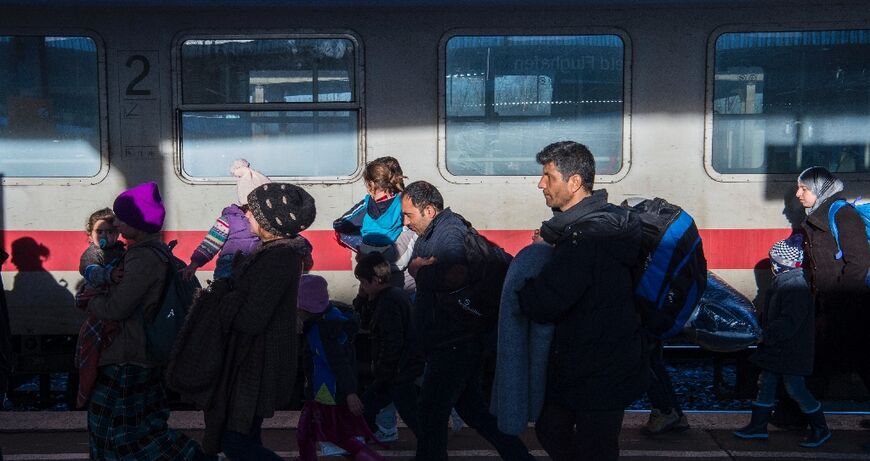 Asylum seekers arrive on a train to Brandenburg in 2015