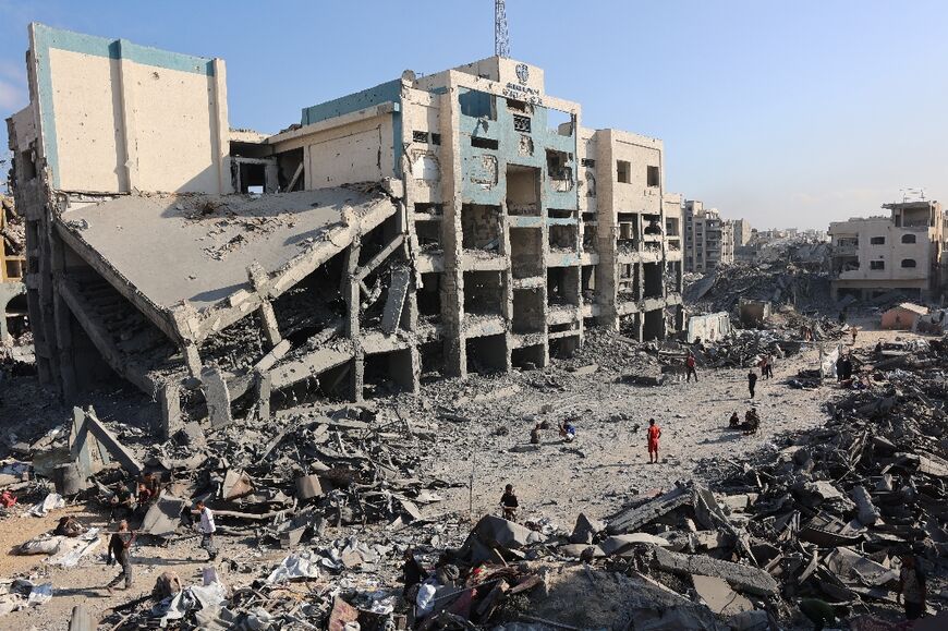 Palestinians inspect the damage after an overnight strike on a UN-run medical centre in northern Gaza