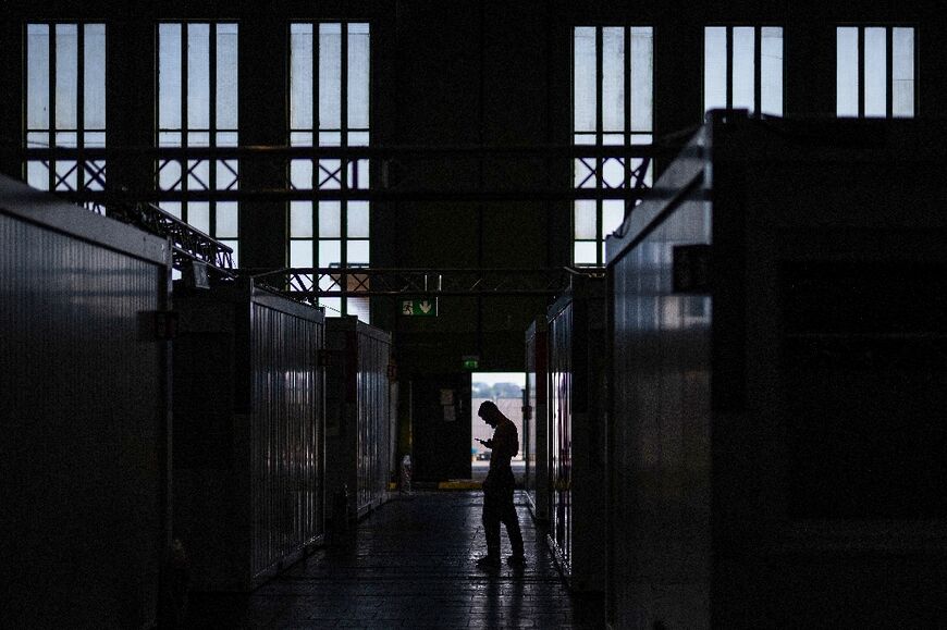 Refugees and asylum seekers live in crowded container facility at Berlin's former Tempelhof airport 