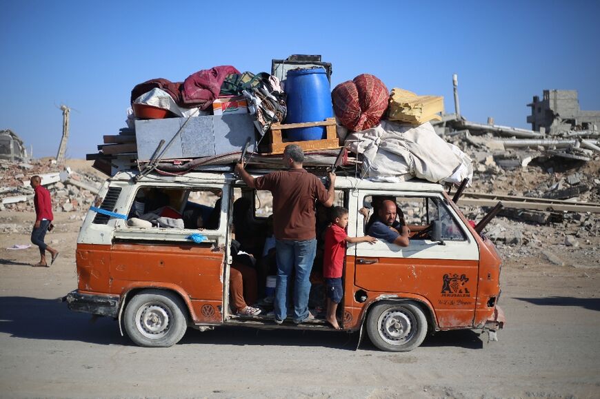 Palestinians move with their belongings southwards on a road in the Nuseirat refugee camp area in the central Gaza Strip following renewed Israeli evacuation orders for Gaza City on September 16, 2025