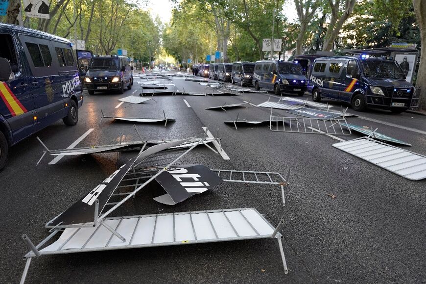 Protesters overwhelmed police and invaded the course in the Spanish capital, forcing organisers to cut short the final stage