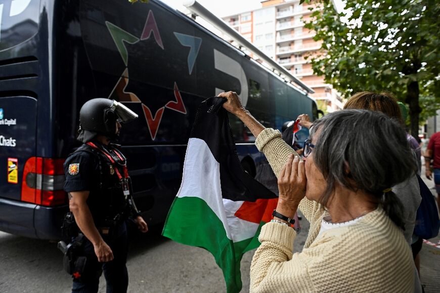 A Pro-Palestinian protester shouts at the Israel-Premier Tech Vuelta team bus