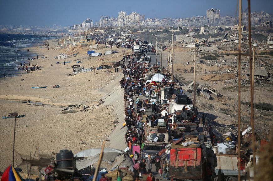 Palestinians move with their belongings southwards on a road in the Nuseirat refugee camp area in the central Gaza Strip following renewed Israeli evacuation orders for Gaza City on September 16, 2025