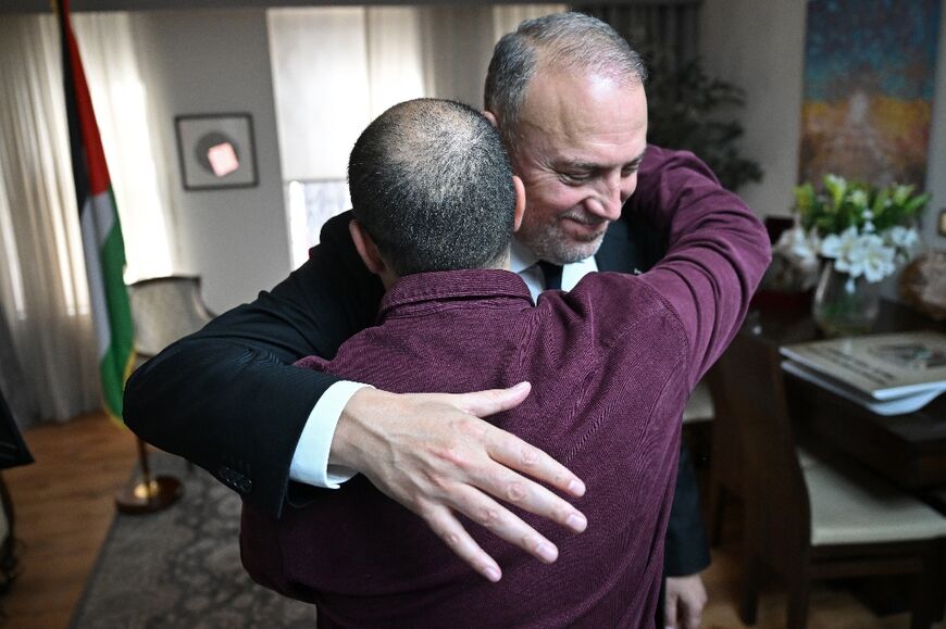 Husam Zomlot embraces a member of staff after Britain's Prime Minister Keir Starmer formally recognised a Palestinian state