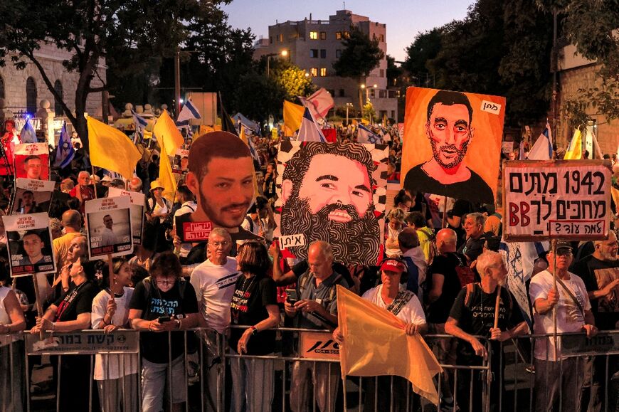 Protesters with posters of Israeli hostages held in Gaza rally in central Jerusalem