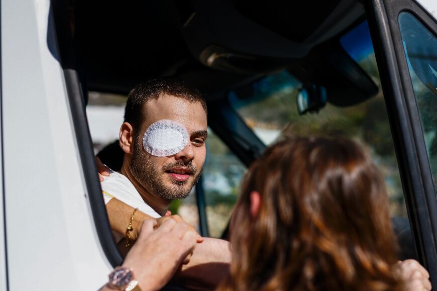 Alon Ohel, a hostage released by Hamas, greets his cheering neighbours as he arrives at his home in Karmiel, northern Israel