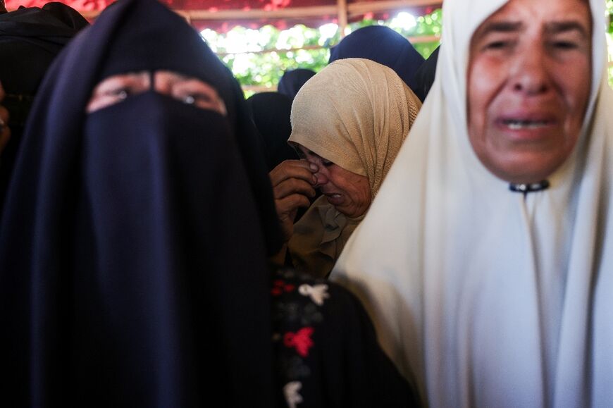 Relatives mourn during the funeral of Palestinians killed in an Israeli strike