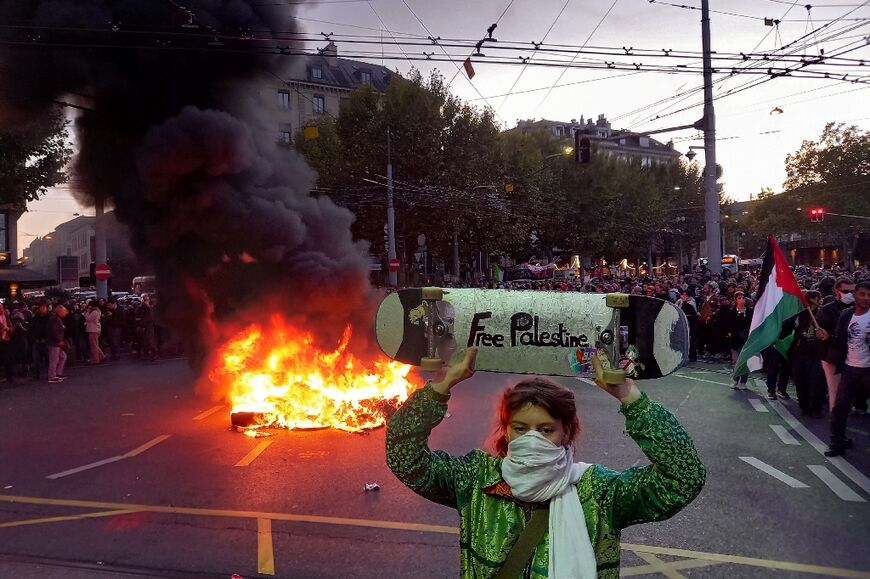A demonstrator holds a skateboard with the inscription "Free Palestine" at a rally in Geneva in support of the flotilla