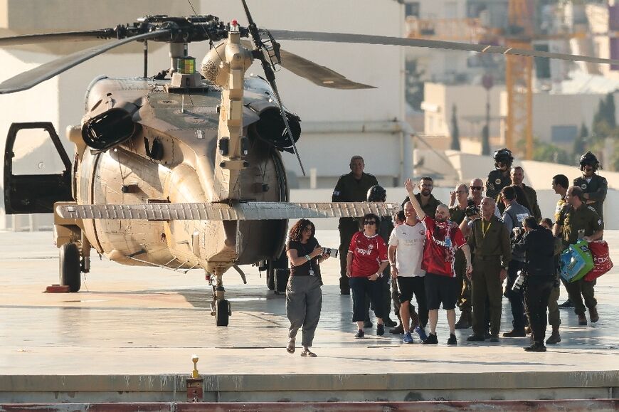 Freed hostages waved after landing back in Israeli