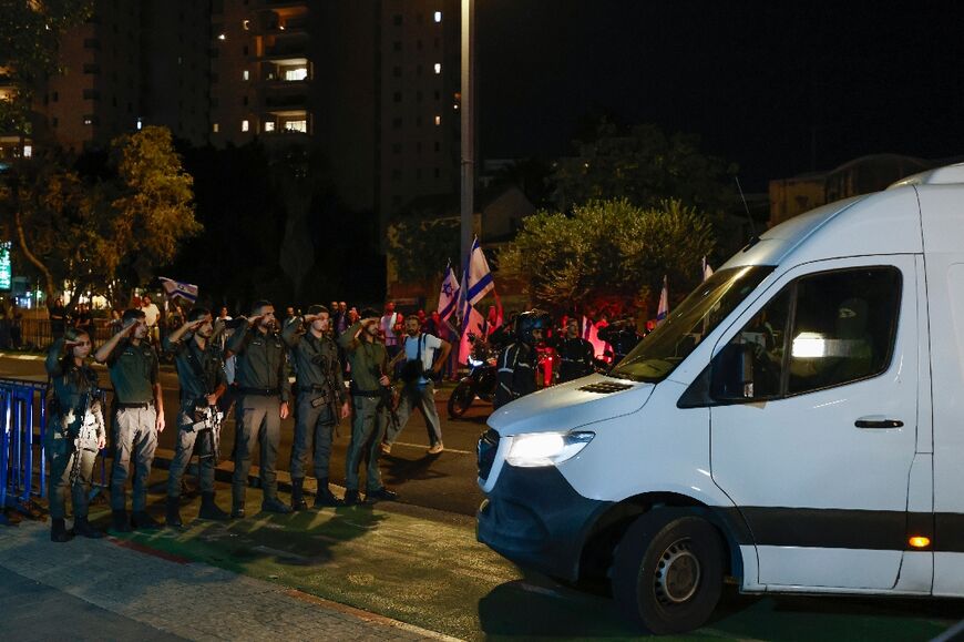 Israeli soldiers salute as four hostage bodies arrive for identification in Tel Aviv