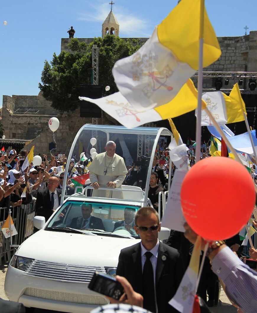 Pope Francis waved to the crowds from his popemobile as he arrived at Manger Square in Bethlehem before presiding over an open-air mass in 2014