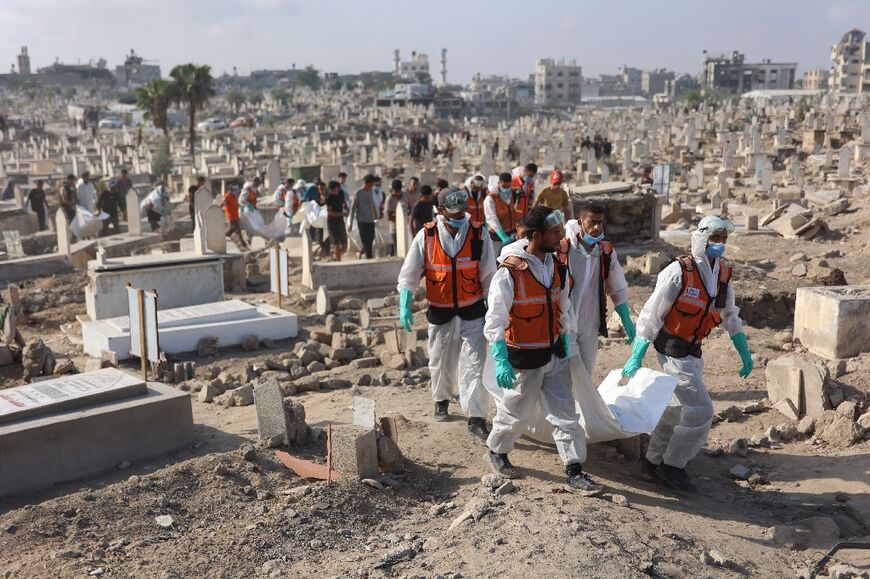 The remains of members of the Shahebar family, who were buried in temporary graves, being taken for reburial at the Sheikh Shaaban Cemetery in Gaza City