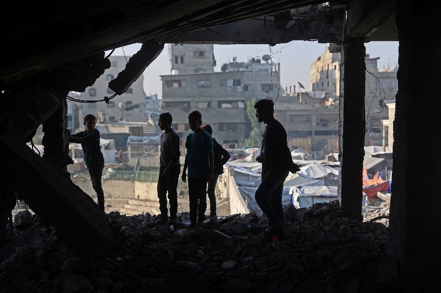 Palestinians inspected the debris of a damaged building in the Zeitoun neighbourhood of Gaza City, the day after a wave of Israeli air strikes