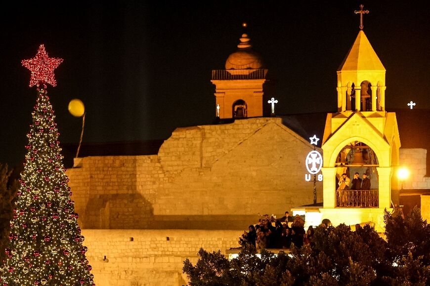 Covered in red and gold baubles, the Christmas tree standing metres away from the Church of the Nativity on Manger Square has become a symbol of hope