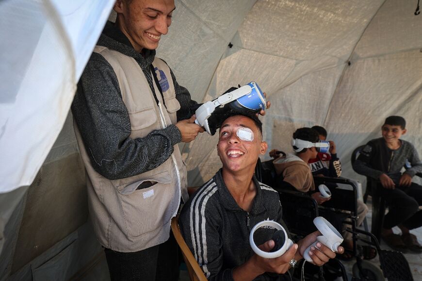 A medical technology support team member gets ready to fit the VR headset