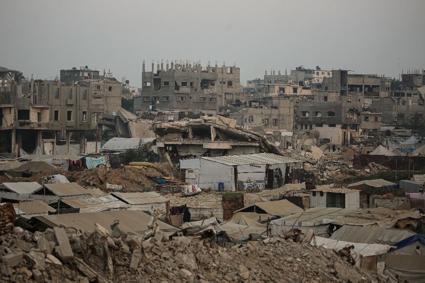 Displaced Palestinians set up their tents surrounded by rubble from buildings destroyed by the Israeli military in central Gaza