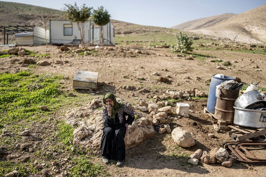 A woman cries as her family pack their belongings and leave home