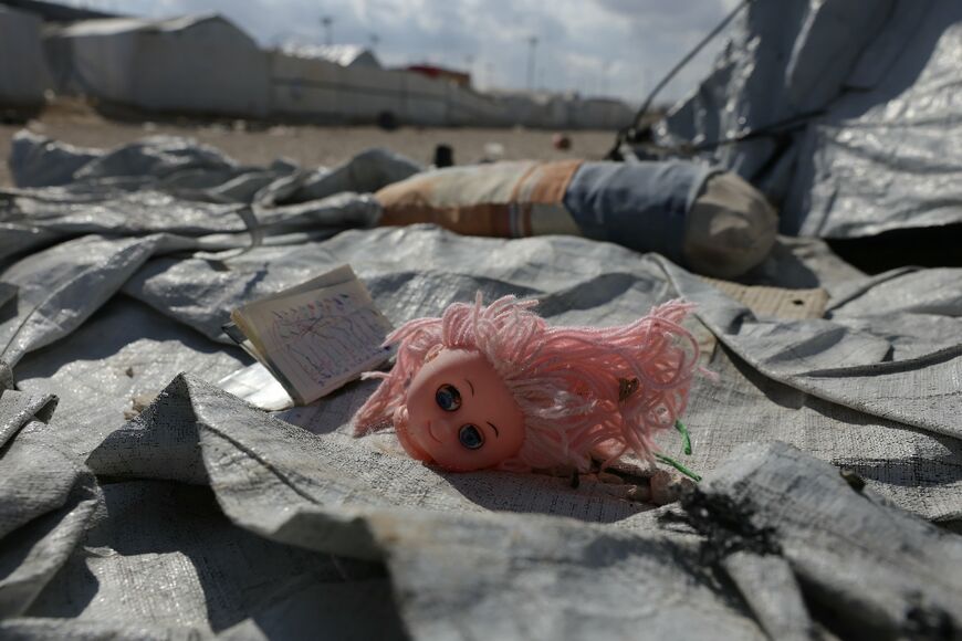 Toys and other mementoes left behind at the camp show how quickly the families departed
