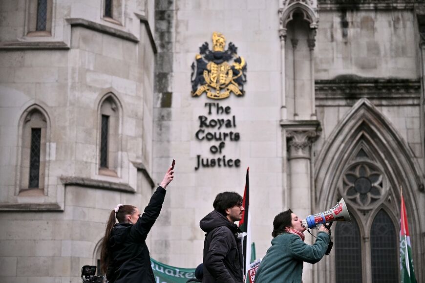A protestor shouts through a megaphone outside The Royal Courts of Justice in London as Palestine Action co-founder Huda Ammori won a legal challenge against a UK government ban on the activist group 