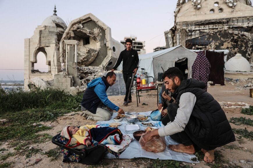 Displaced from their homes, Palestinians in Gaza break fast during the holy month of Ramad