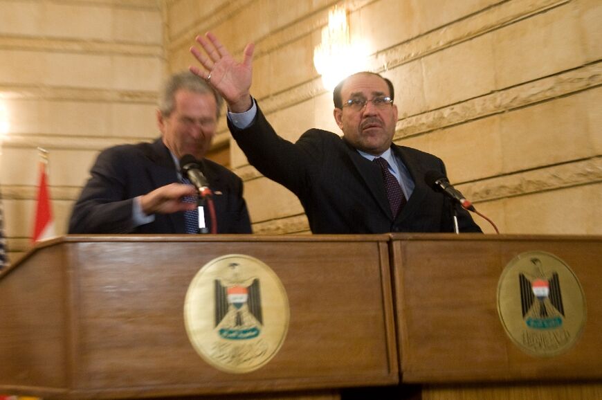 Then prime minister Nouri al-Maliki tries to block a shoe being thrown at then US president George W. Bush in 2009