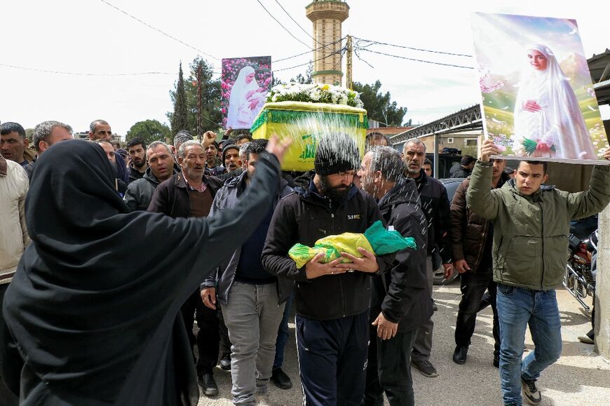 Mourners at the funeral of a woman, who was eight months pregnant with twins, killed the previous day in an airstrike on town of Bazaliyeh in Lebanon's eastern Bekaa valley