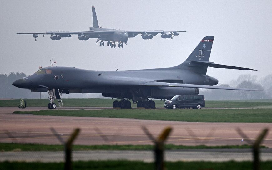 A US Air Force Boeing B-52 Stratofortress bomber jet lands on the runway, beyond a USAF Rockwell B-1 Lancer bomber jet, at RAF Fairford in south west England on March 9, 2026.