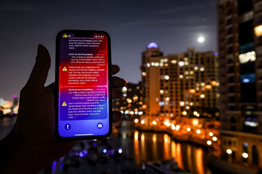 An alert issued by the UAE Ministry of Interior warning residents of Dubai and Abu Dhabi of a potential Iranian missile strike is displayed on a mobile phone shortly before a missile was intercepted on March 5