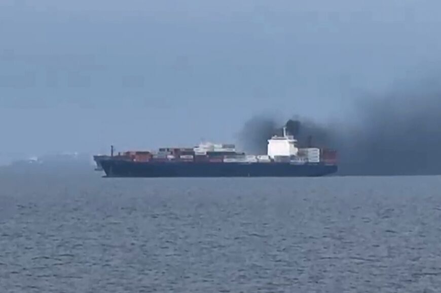 This image, taken from video footage shot by seafarer Wang Shang on Thursday, shows smoke billowing from a cargo vessel in the Gulf