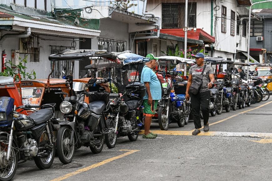 Tricycle taxi drivers in Manila are also struggling with rising fuel costs.