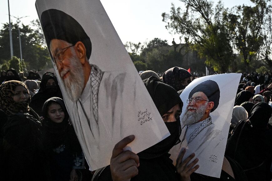 Shiite Muslims hold portraits of Iran's late supreme leader Ayatollah Ali Khamenei as they protest at the US embassy in Islamabad on March 1, 2026