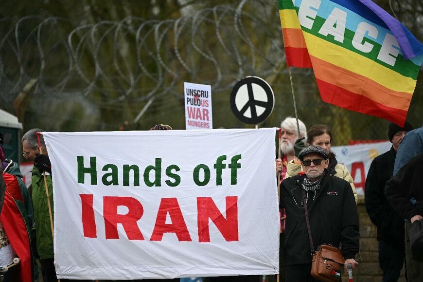 Anti-war protesters gathered with banners at an entrance to RAF Fairford in England
